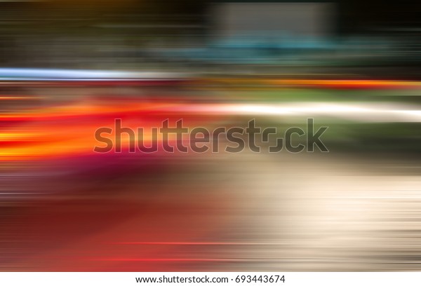 Absrtact  blurred
lights of moving cars in the night city.Bokeh urban background.
Blurred  moving  traffic  
