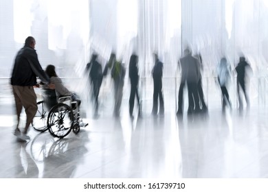 abstakt image of people in the lobby of a modern business center with a blurred background - Powered by Shutterstock