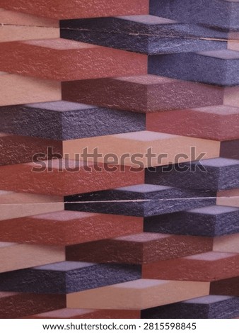  Abstract 3D geometric wall tile pattern with textured cuboid shapes in terracotta, brown, and dark purple tones.
