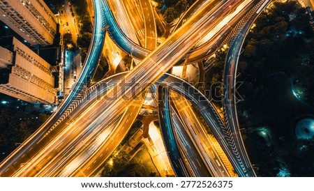 Abstract aerial pattern of intersecting highways with night traffic light streaks