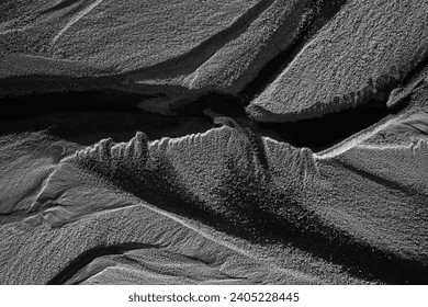 Abstract aerial photograph of a dried-up riverbeds in southern Iceland. Black ash, sand and lava gravels.