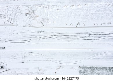 abstract aerial view of snow-covered road with tire tracks. winter transport concept background
