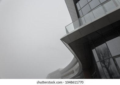 Abstract architectural background. Element of the facade of a modern building in dense fog