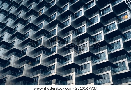 Abstract architectural background of modern skyscraper geometric facade pattern with metallic balconies and windows of Vancouver House, Vancouver, British Columbia, Canada.