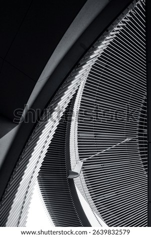 Abstract architectural pattern with curved metallic structure and repetitive lines
