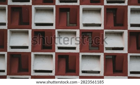 Abstract architectural pattern of a modern geometric building facade with repeating square elements.