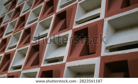 Abstract architectural pattern of a modern geometric building facade with repeating square elements.