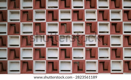 Abstract architectural pattern of a modern geometric building facade with repeating square elements.