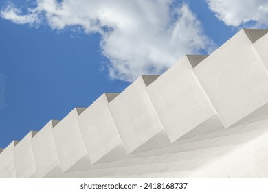 Abstract architecture background. Modern white concrete structure, stairs steps,  geometric shapes pattern, against blue sky with clouds. Contemporary, minimalist concept. Architectural photography - Powered by Shutterstock