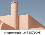 Abstract architecture details background. Modern buiding exterior walls. Architectural exterior design in clear orange against blue sky. Contemporary. Minimal. Geometric. Peach Fuzz colour. Empty