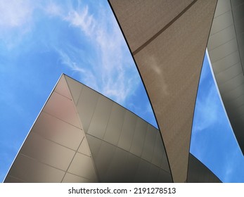 Abstract Architecture And Material Design With Curvy Roof And Tent. Close-up Of Modern Buildings. Minimal Exterior Background With Curve Structure. Geometric Composition Of Curves Against Blue Sky.