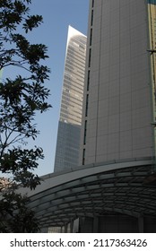 Abstract Architecture View Of Dramatic City Buildings. Triangular Angular Architectural Detail Of Modern Building Structure. Futuristic Urban Glass And Steel Facade Commercial Constructions. 