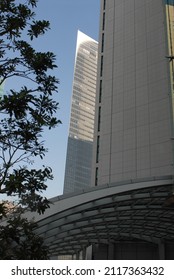 Abstract Architecture View Of Dramatic City Buildings. Triangular Angular Architectural Detail Of Modern Building Structure. Futuristic Urban Glass And Steel Facade Commercial Constructions. 