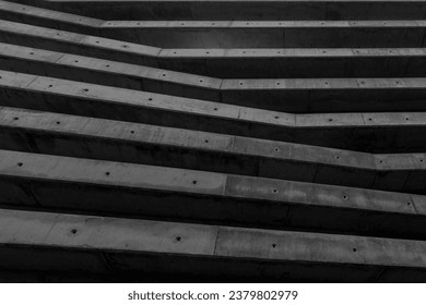 abstract architeture background made of geometric shape wall pattern. exterior detail. contemporay construction with large cement columns or beams grid. brutalist structure buildind. Black and white