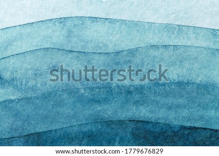Abstract art background navy blue colors. Watercolor painting on canvas with turquoise pattern of sea waves. Fragment of artwork on paper with wavy line and gradient.