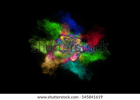 Abstract art colored powder  on black background. Movement frozen colored dust explosion multicolored on black background. 