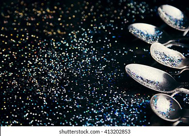 Abstract art concept with multicolored glitter and spoons. Idea of the sky, space, music and subcultures. Background. Texture.