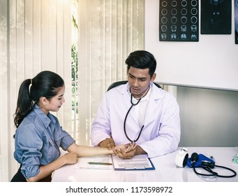 The Abstract Art Design Background Of The Doctor Is Pressing On The Patient's Arm,for Checking Heart Rate,warm Light Tone,blurry Light Around