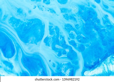 Abstract art texture background. Flowing emulsion design. Beautiful sky blue paint with bubbles and glitter.