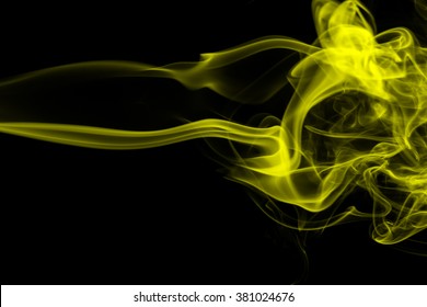 Abstract art. Yellow smoke hookah on a black background. Inhalation. The steam generator. The concept of poison gas.
