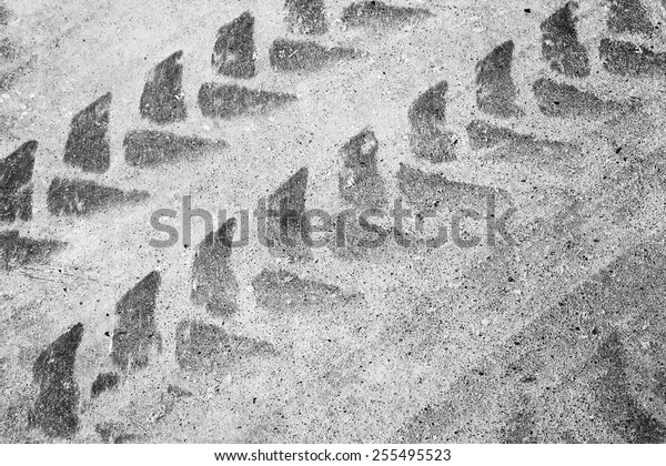 Abstract asphalt road fragment\
with tire track pattern, automotive transportation\
background