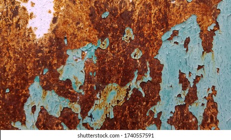 Abstract backdrop of rusty metal texture with blue flaking paint and copy space. Anti-corrosion paint concept