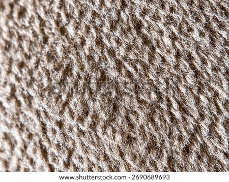 Abstract background of a beige fleecy surface, closeup 