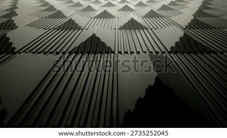 Abstract background of black 3D wall panels with a pyramid texture and linear patterns. Modern architectural interior design element
