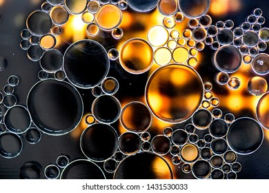 Abstract Background. Black And Yellow Oil Bubbles On Water