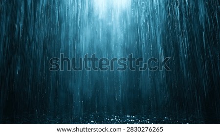 Abstract background of blue light rays penetrating deep dark water, creating a mystical and serene atmosphere.