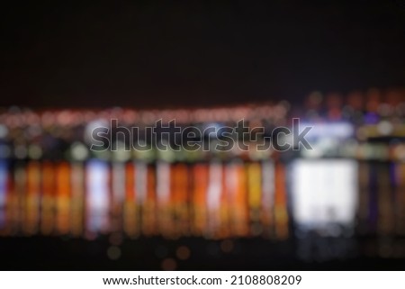 abstract background blur of urban lights on the beach lit up at night.