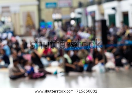 Abstract background, blurred crowd waiting for a ride in Bangkok Thailand Railway Station.