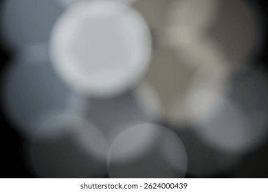 Abstract background with blurred light circles creating a soft bokeh effect in neutral gray tones, perfect for use in design, texture, or artistic compositions. - Powered by Shutterstock - Get 15% off with code: PIKWIZARD15