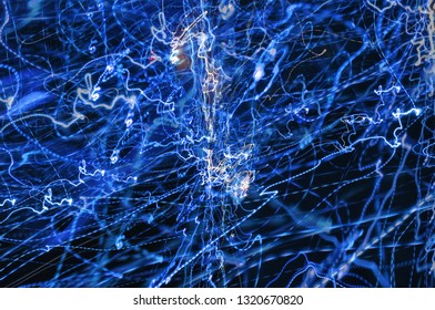 Abstract background of blurry chaotically mixed light strips of blue color