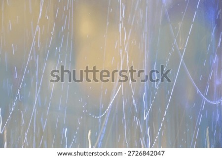 Abstract background with bokeh effect, glowing lines of garlands and soft highlights in pastel colors.