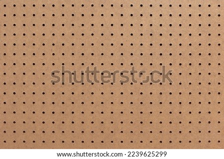 Abstract background of brown perforated hardboard sheet, Plywood with pre-drilled with evenly spaced holes Nature seamless pattern texture, Surface and details of brown wood plank.