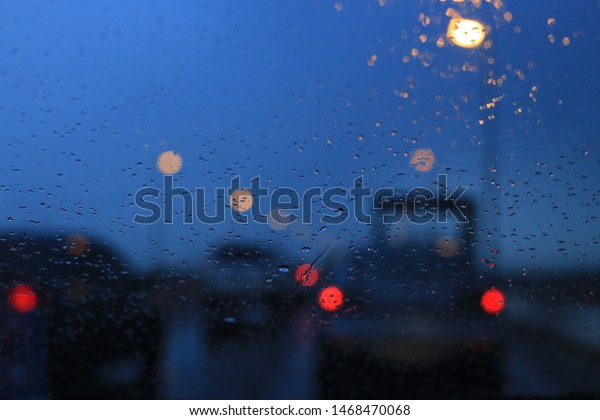abstract\
background of car taillight bokeh. expressway road highway dusk and\
storm. twilight hour raining in the street. \

