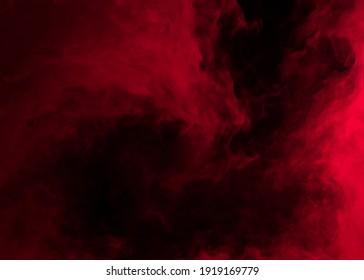 Abstract Background Of Chaotically Mixing Puffs Of Red Smoke On A Dark Background