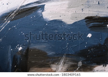 Abstract background chaotically smeared with acrylic paint. Image of a blue, white, black and brown strokes of brush with texture of wet stucco.