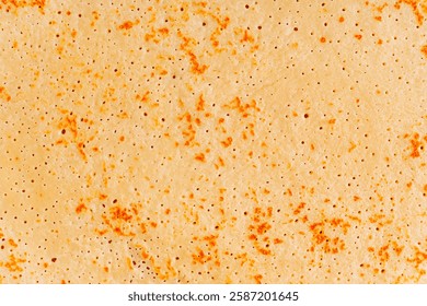 Abstract background of closeup top view of buttery texture of surface of sweet homemade french crepe dessert or fried blini snack made from batter usually served for morning breakfast or brunch