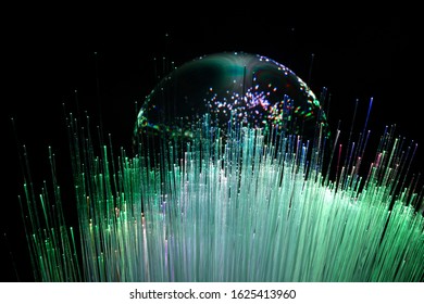 abstract background with colored fibers optics reflected on glass sphere