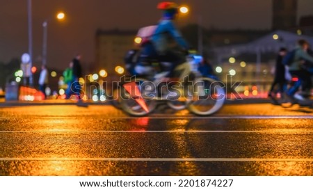 Abstract background of colored group of bicyclists on a city street. Parade of bicyclists, blur effect, unrecognizable faces. Sport, fitness and healthy lifestyle concept.