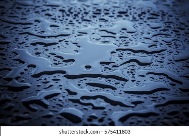 Abstract Background With Copy Space. Water Drops On Blue Metal Table Surface. 