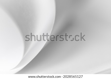 abstract background of curved sheets of paper close-up with a shallow depth of field (blurred)
