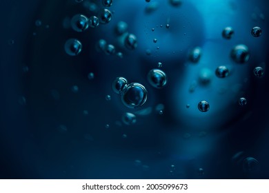 Abstract background of dark blue color bubbles in liquid. 
