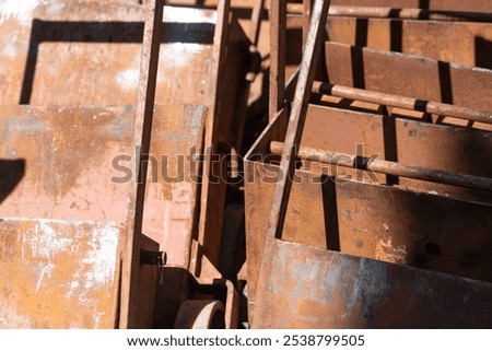 abstract background featuring rusty metal objects with some paint outdoors