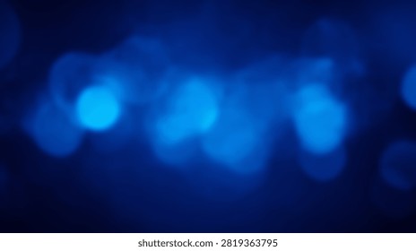 Abstract background featuring soft blue bokeh lights with a dark, moody atmosphere and gentle glow.