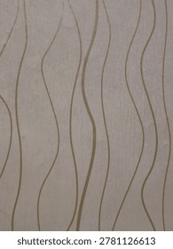 Abstract background featuring vertical, flowing wavy lines in a gold or light brown tone against a textured cream-colored surface. 