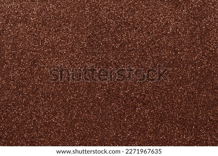 Abstract background filled with shiny dark brown glitter