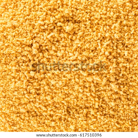 Abstract background of golden Breadcrumbs. Texture. Top view.